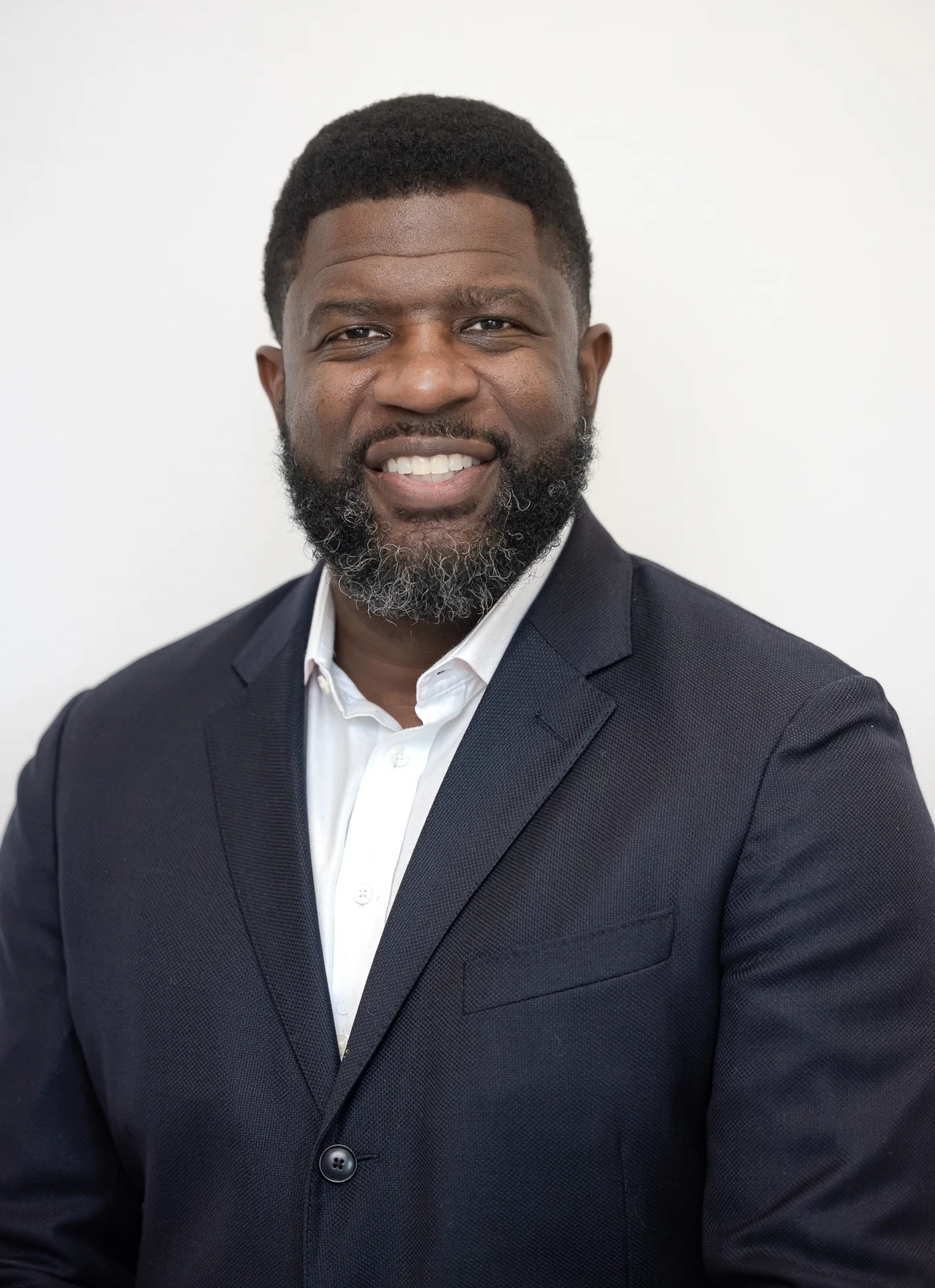 Professional headshot in a navy suit