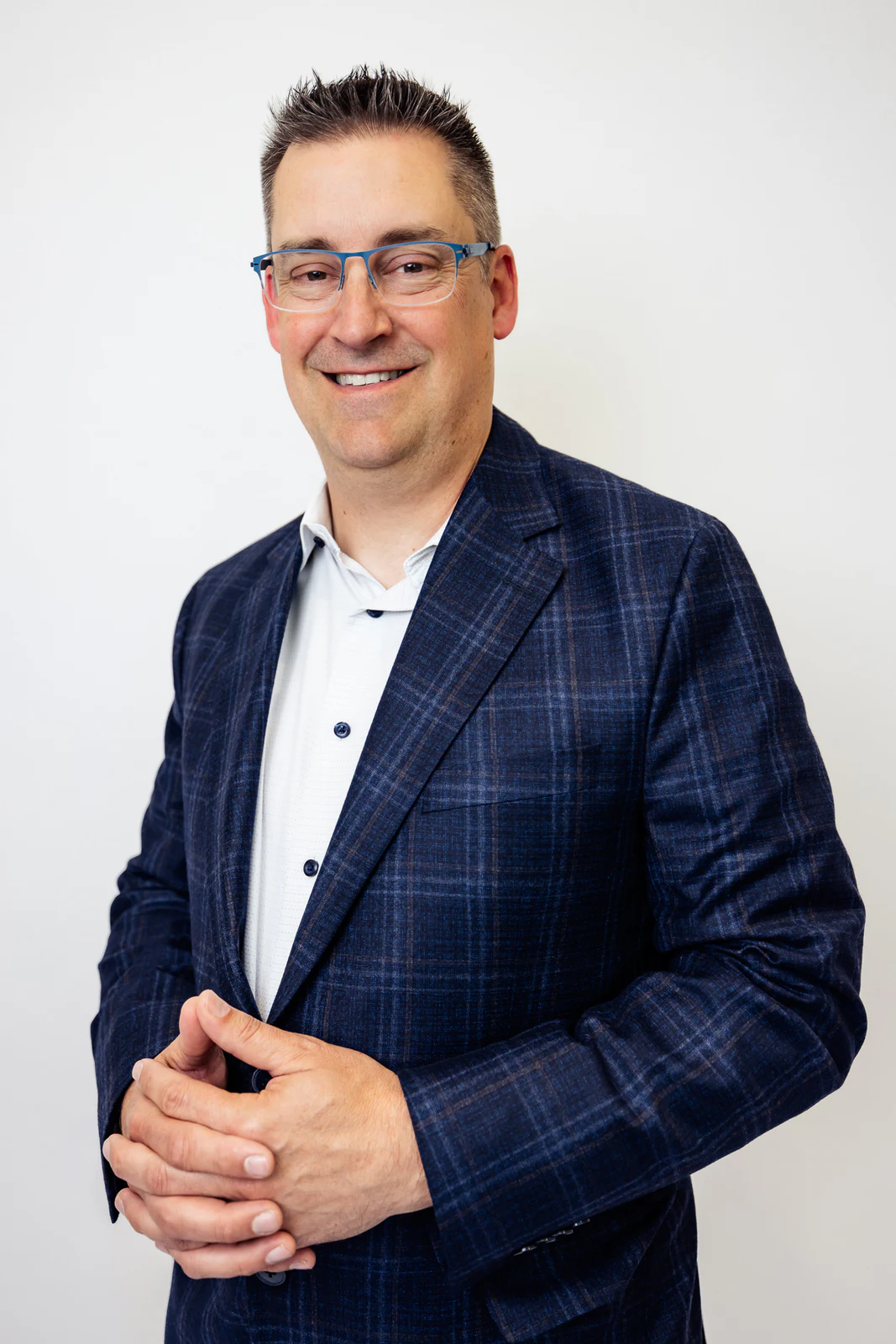 Standing portrait in a blue checked suit