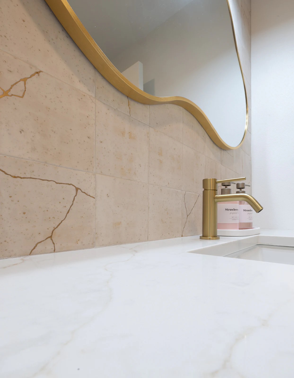 Curved mirror and stone backsplash detail