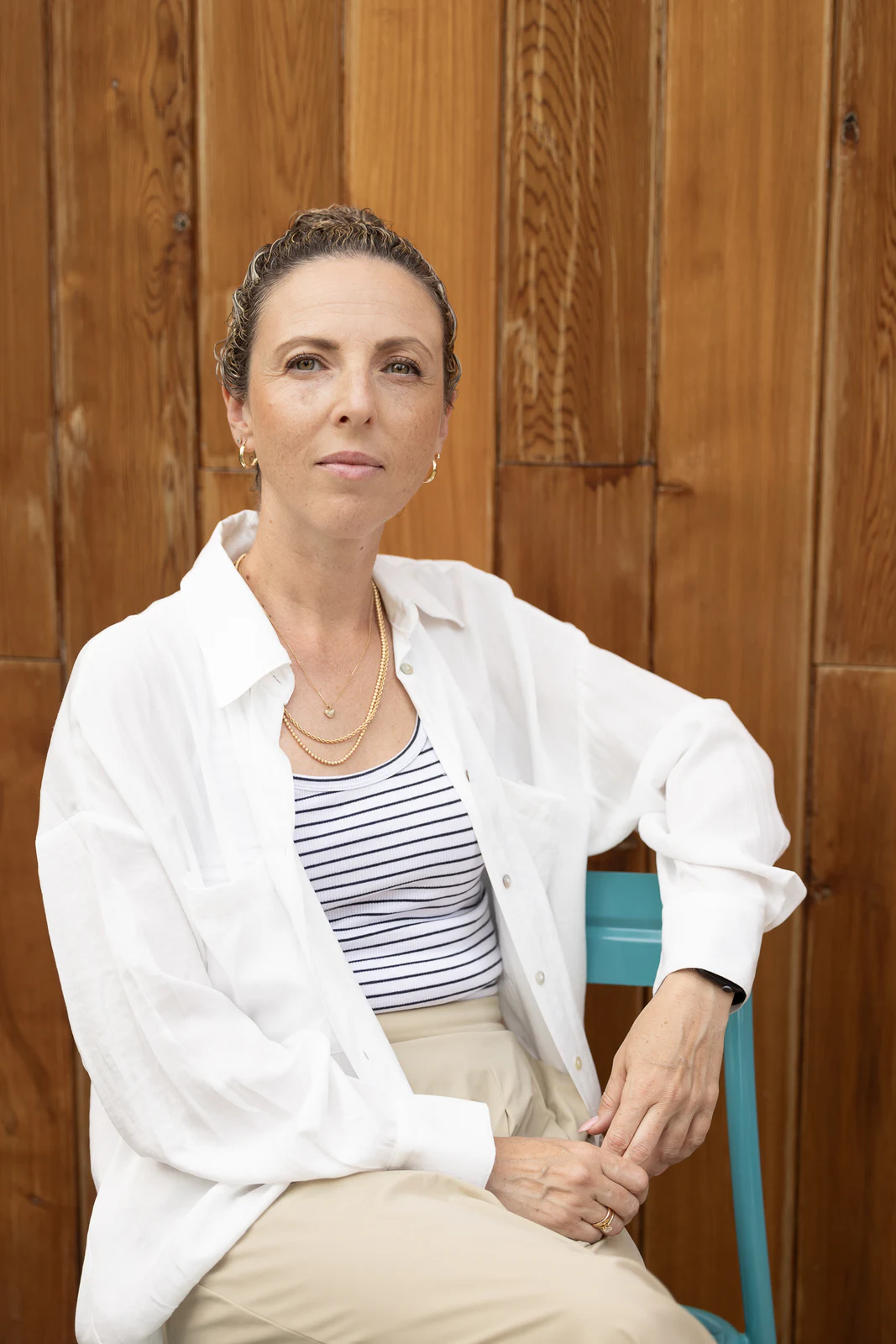 Casual seated portrait in a warm wood kitchen