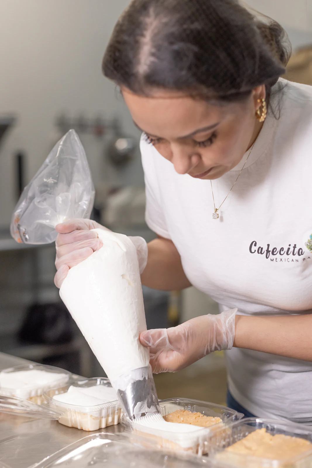Pastry chef piping filling into desserts