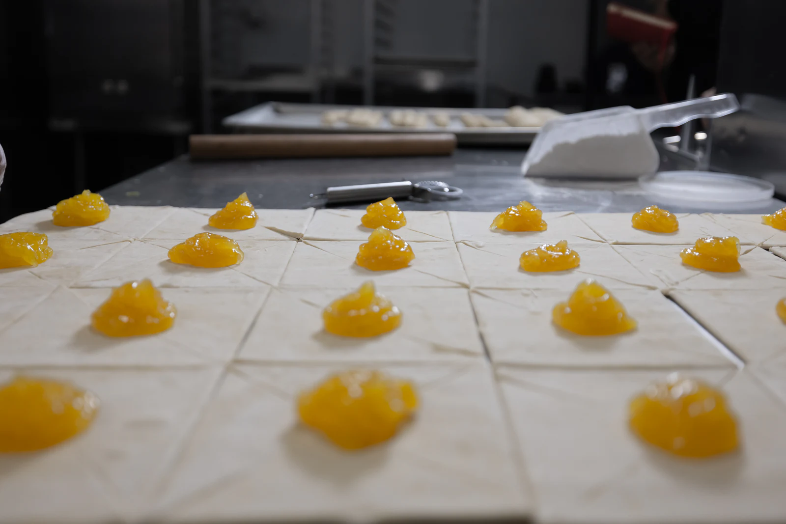 Rows of pastries dotted with golden filling